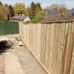 Domestic sleeper retaining wall with close board fencing