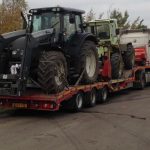 2 Tractors on a trailer, arriving on a job