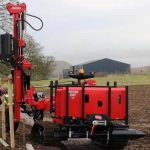 Fence post driver in action