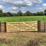 Wooden farm gate and netting fence near Devizes